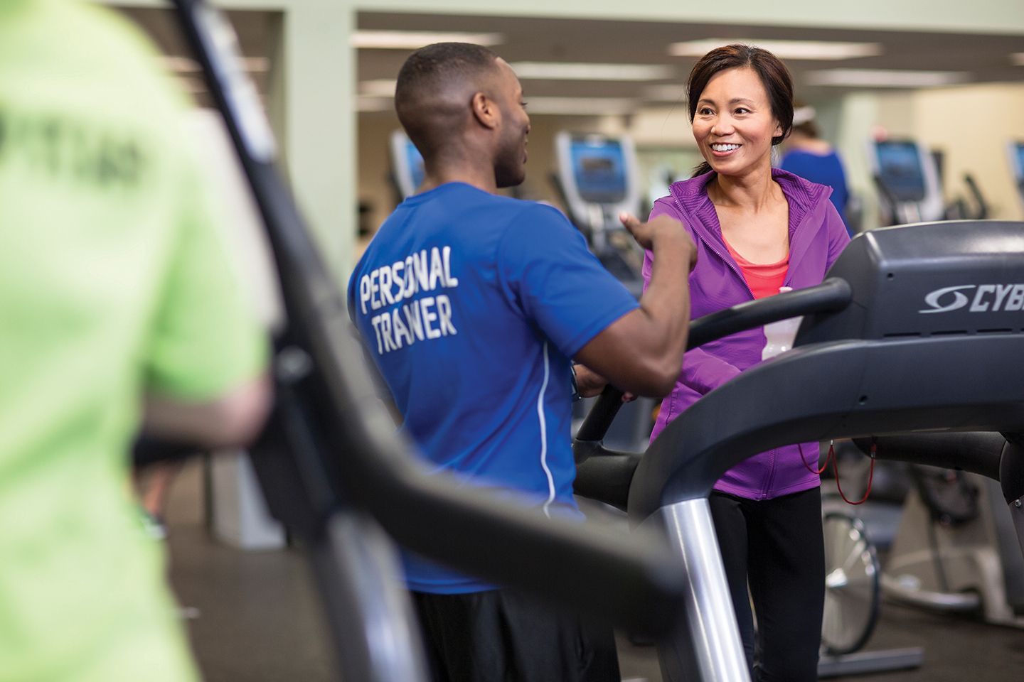 male personal trainer talking to female client